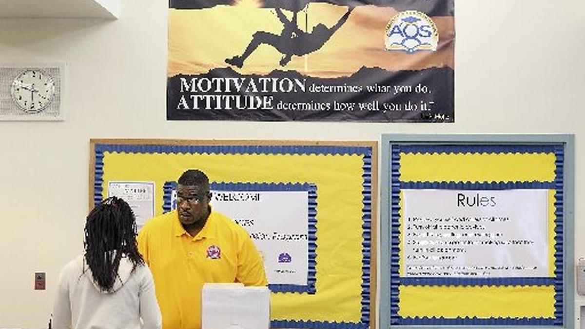 In 2015, Maxie Graham, site coordinator at a Student Success Center in Miami, providing an alternative to out-of-school suspension, reviews a student’s classwork.