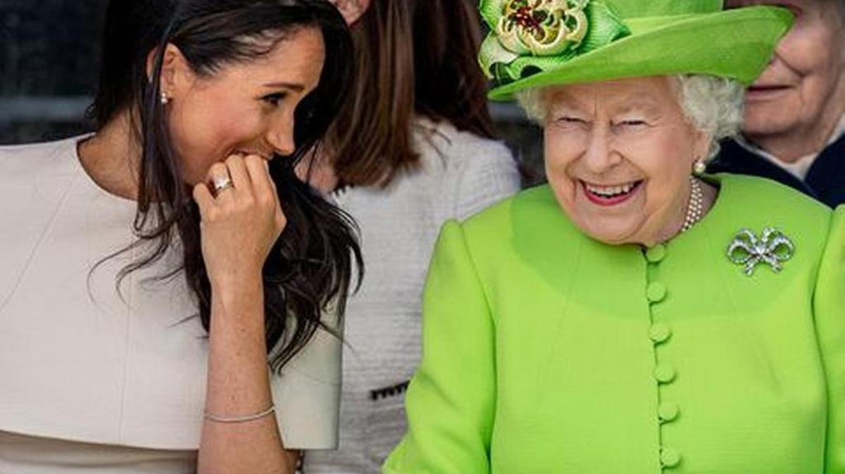 Meghan Markle and her grandmother-in-law Queen Elizabeth share a laugh at a children’s performance in Cheshire, England.