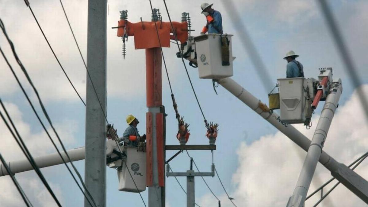 FPL workers replace wood poles with stronger ones of concrete.