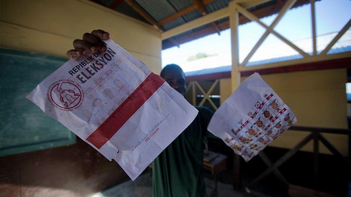 
A man rips an election ballot after a voting center was closed by authorities when fistfights broke out on Aug. 9.
