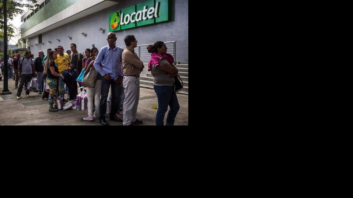 
MISERY INDEX: Shoppers wait in line outside a pharmacy in Caracas that had just received a shipment of diapers. Lines have become common due to a shortage of goods.
