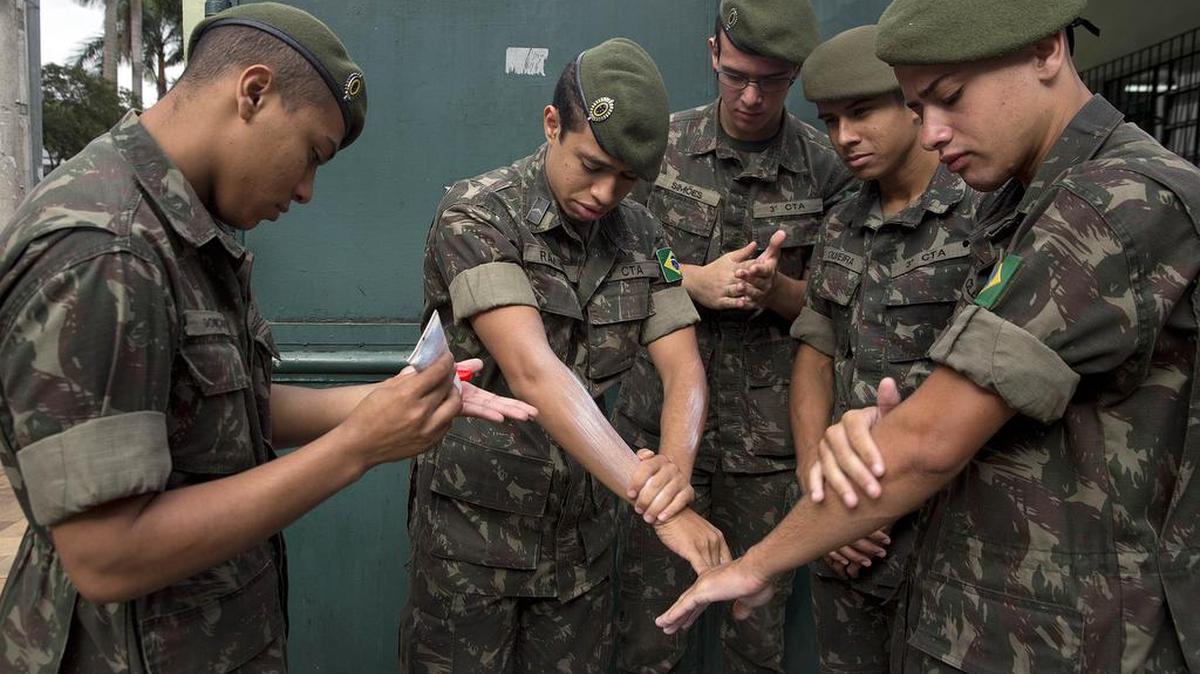 Soldiers apply insect repellent as they prepare for a clean-up operation against the Aedes aegypti mosquito to control an outbreak of the Zika virus in Sao Paulo, Brazil.