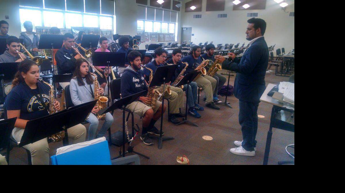 
‘MILLION DOLLAR BAND’: Bandleader Juan Turros of Miami Senior High directs the school’s Stingaree Band in practice. 
