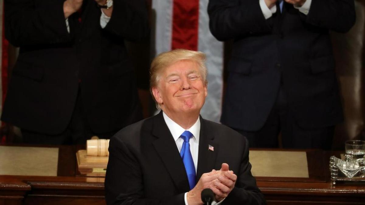 President Trump applauds during his first State of the Union Address.