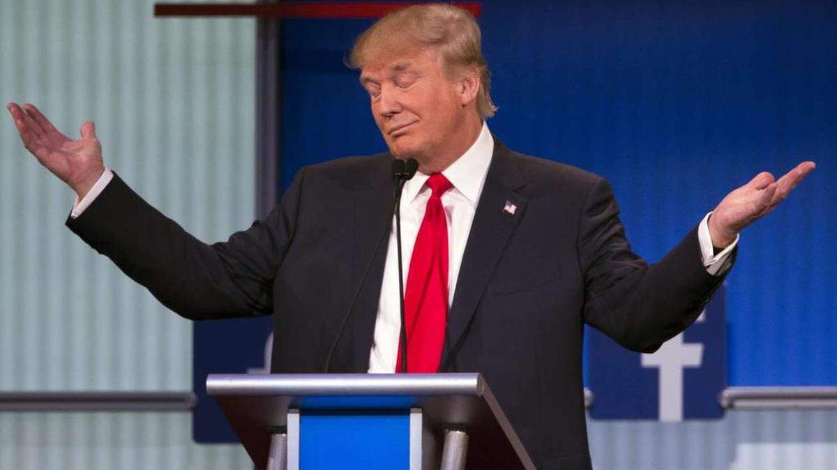 Donald Trump shrugs during the first Republican president debate in Cleveland.