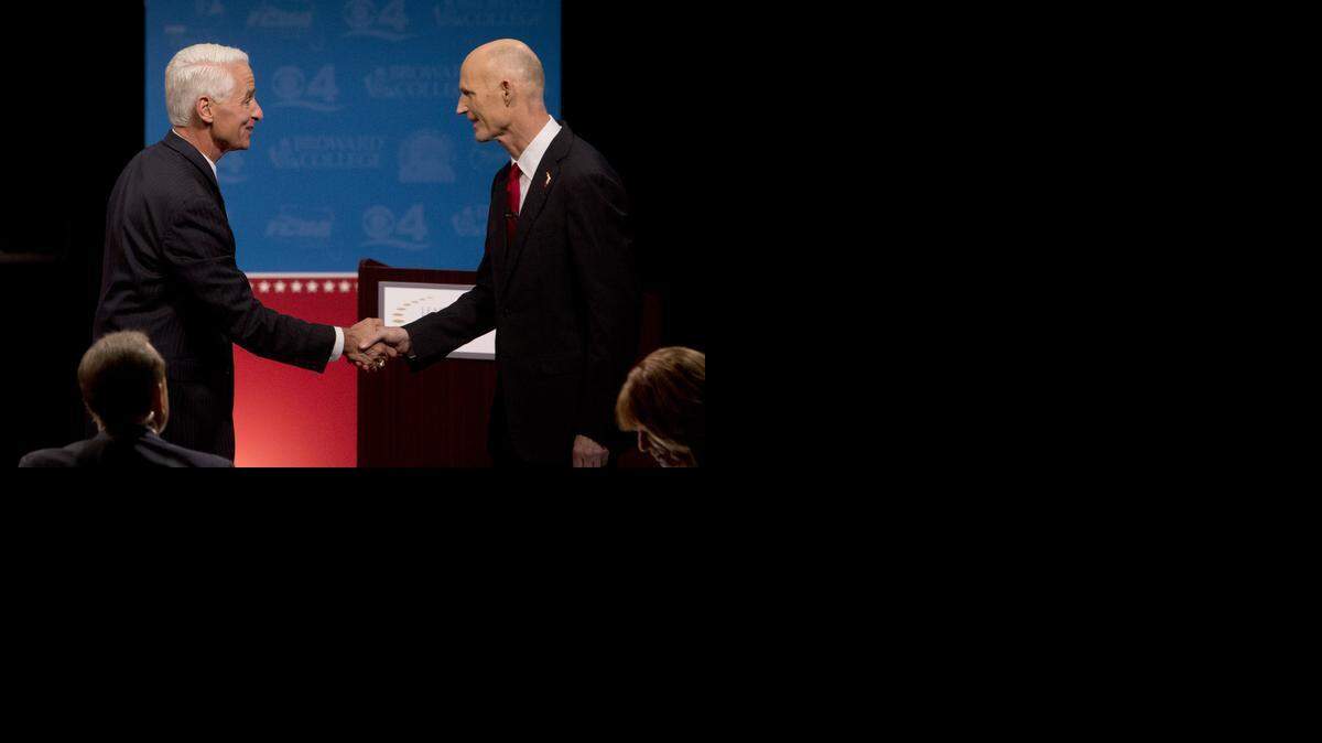 
POST-DEBATE: Former Gov. Charlie Crist, left, and incumbent Gov. Rick Scott shook hands after their second debate last week.
