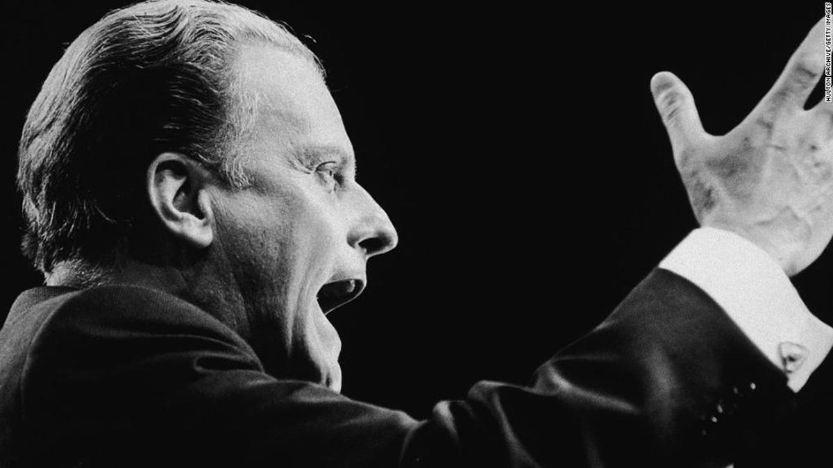 Billy Graham, addressing a London congregation in 1966, is nicknamed “America’s pastor.”