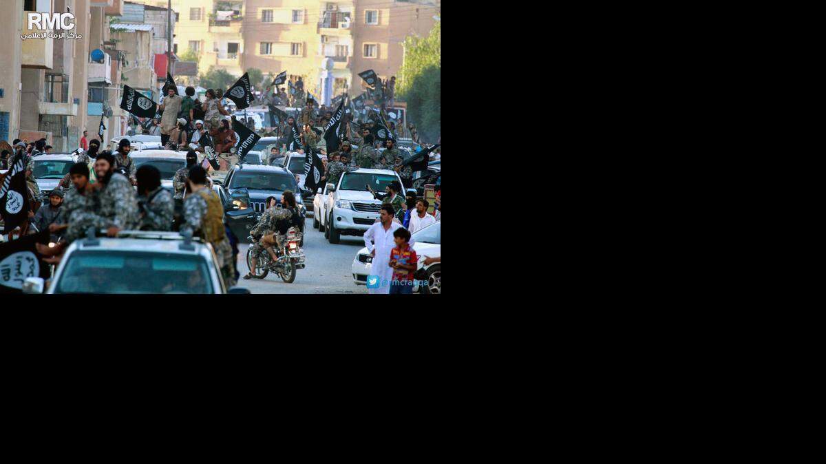 
ISLAMIC STATE: Members of the terrorist group parade in a Raqqa, Syria, after taking over the city last summer.
