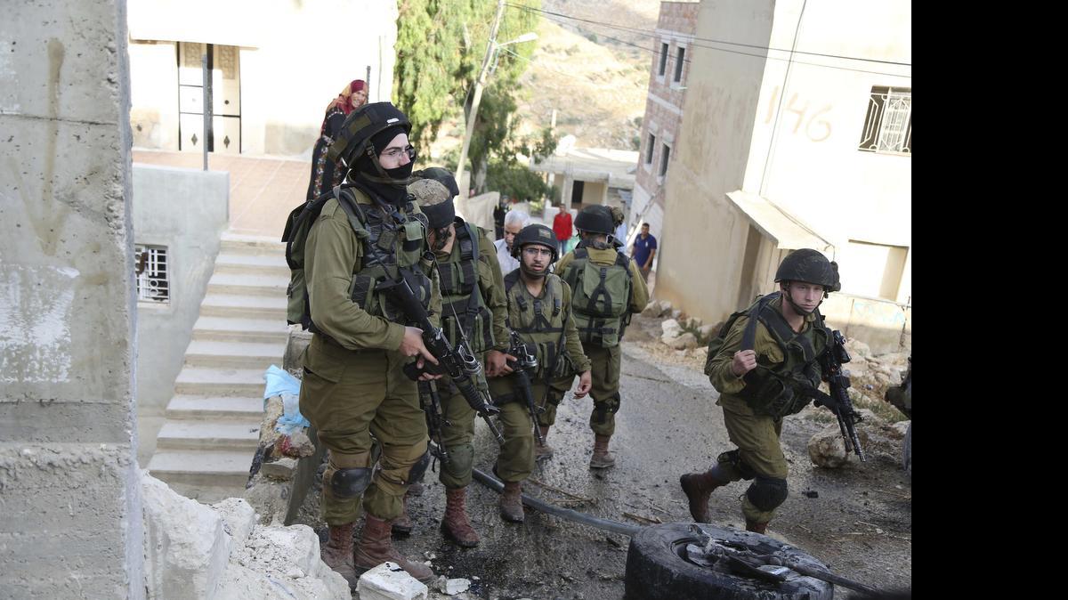 
WEST BANK: Israeli soldiers enter the village of Kafr Malik after a Palestinian was killed in clashes last Sunday. 
