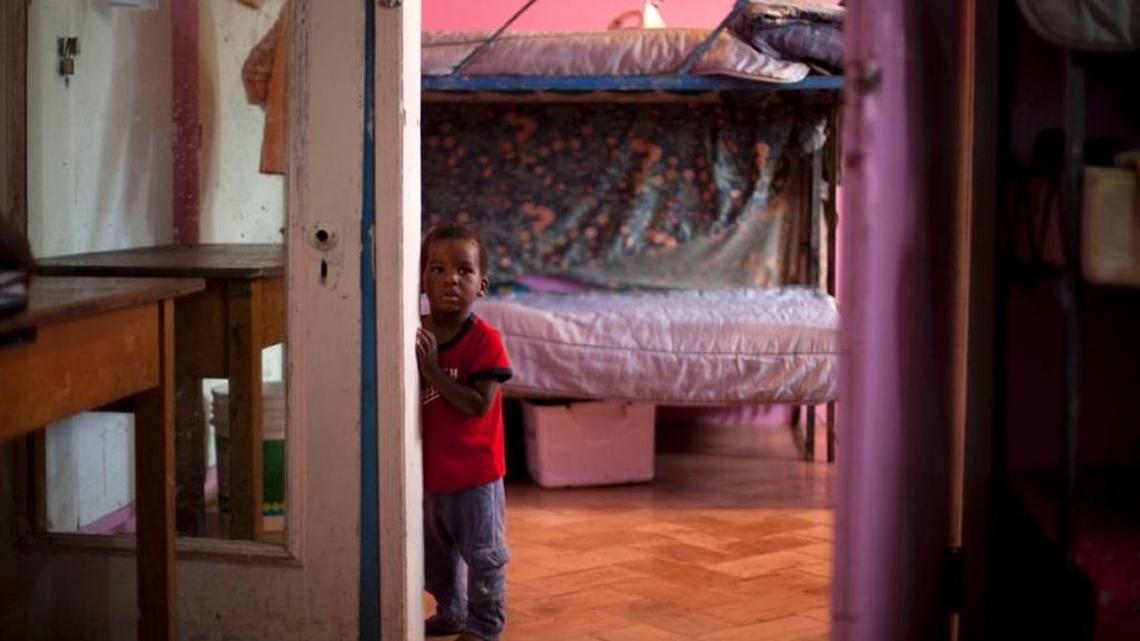 In this 2013 photo, a boy stands in his room in the U.S.-based Church of Bible Understanding orphanage in Kenscoff, Haiti, a facility run by a Christian missionary group funded by an antique store in Manhattan.