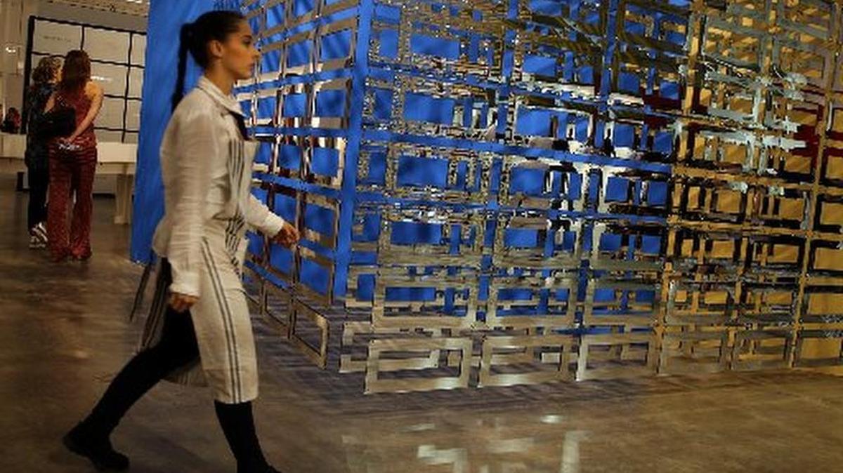 A woman walks past a piece by artists Carla Arocha and Stephane Schraenen at Pinta Miami 2015 art fair in Wynwood.