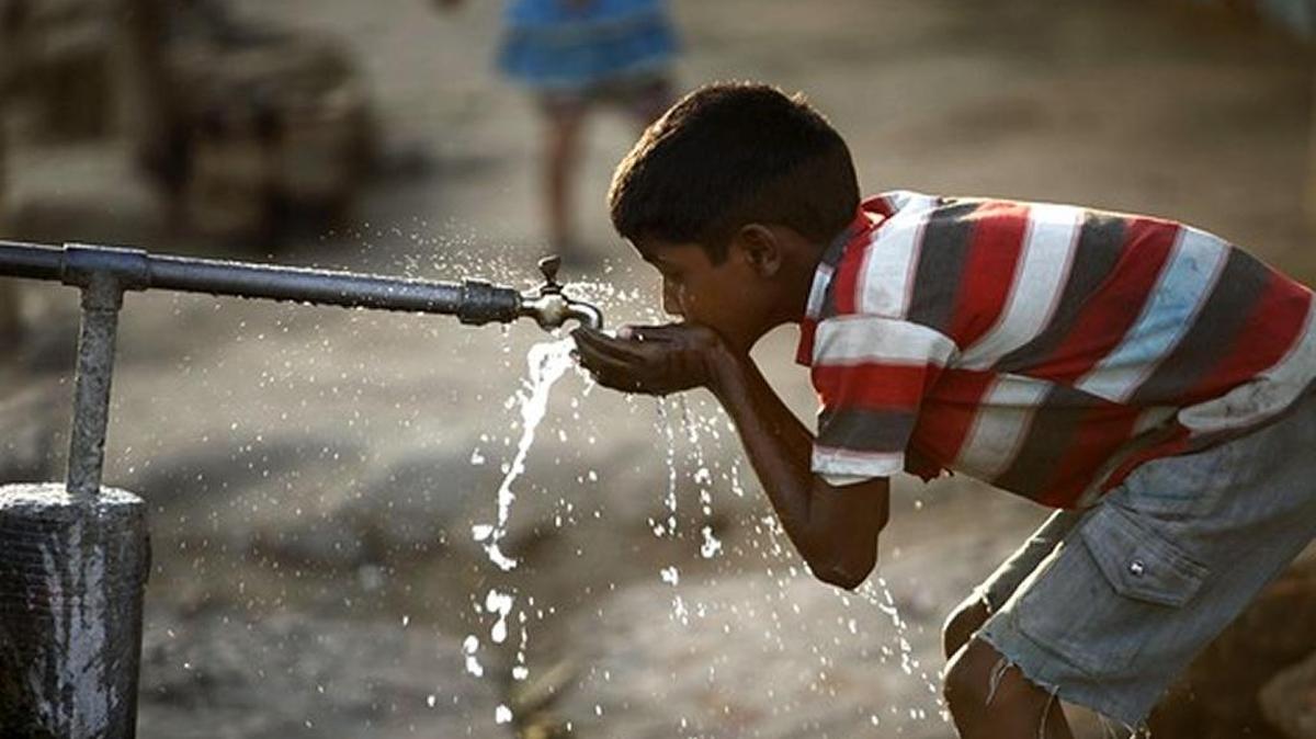 A boy drinks water from a roadside tap in northern Indian city of Allahabad, Uttar Pradesh, where clean water is scarce.