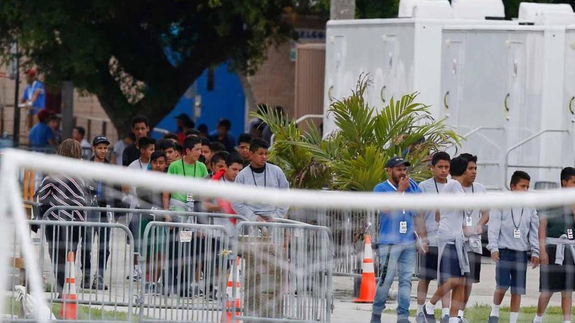 On June 20, immigrant children walk in a line outside the Homestead facility where they are being housed.