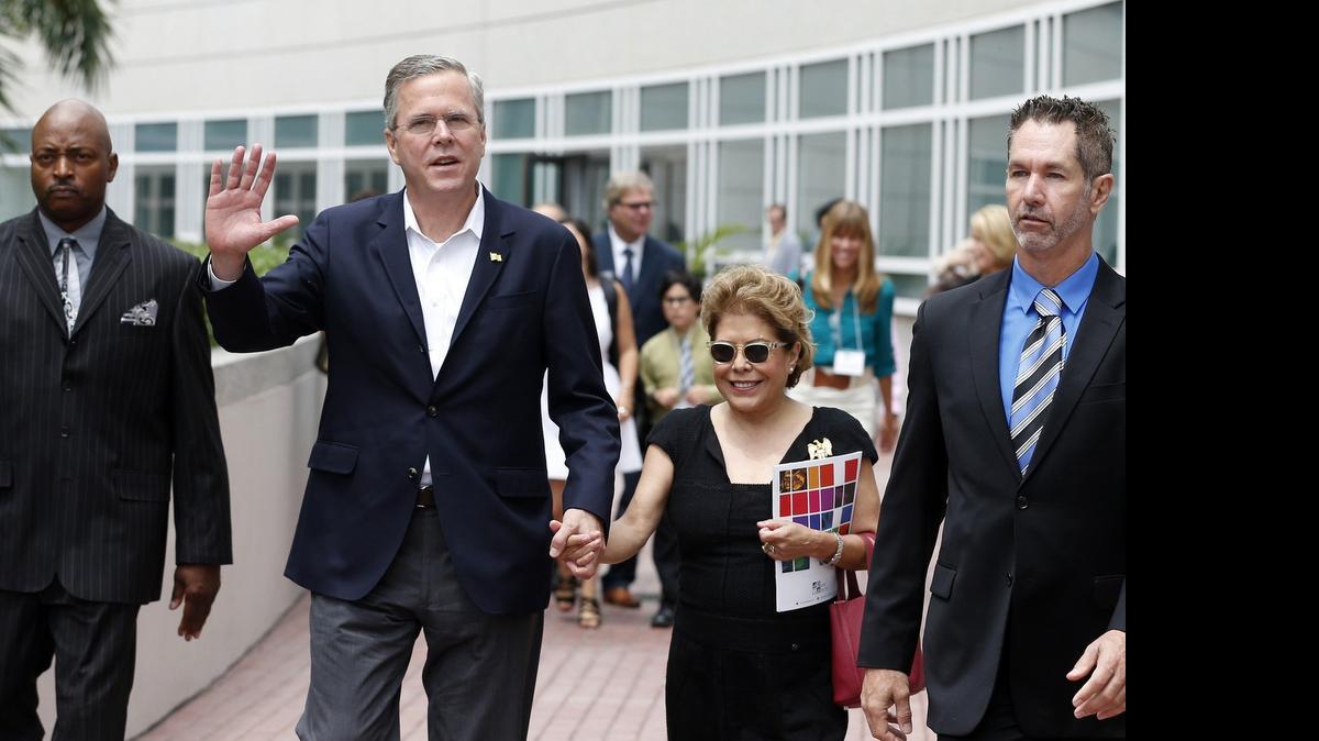 
GETTING READY: Jeb Bush and his wife, Columba, walk across the bridge over Biscayne Boulevard at the Adrienne Arsht Center for the Performing Arts to attend a luncheon honoring arts scholarship winners last week.
