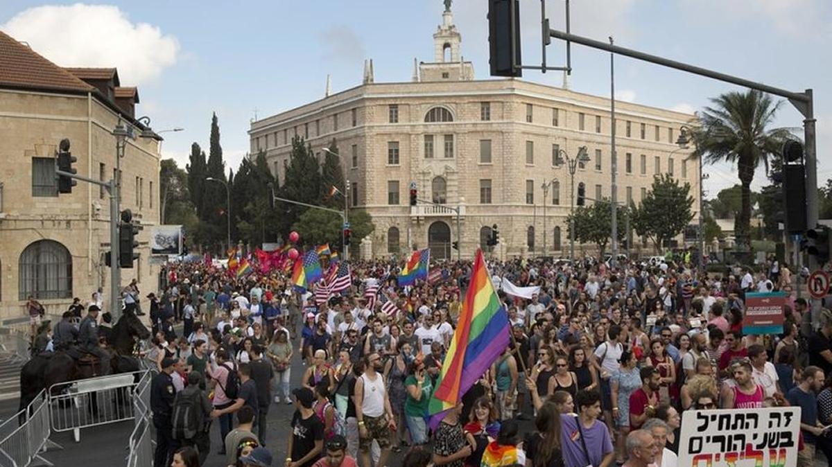 Over 15,000 people marched in the Gay Pride Parade through Jerusalem on Thursday, partying in the shadow of a recently passed surrogacy law that excludes homosexual fathers and outraged the gay community.
