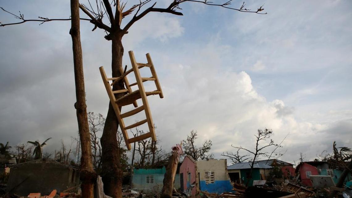 A chair hangs in a tree in October amid homes destroyed by Hurricane Matthew, in a seaside fishing neighborhood of Port Salut, Haiti.