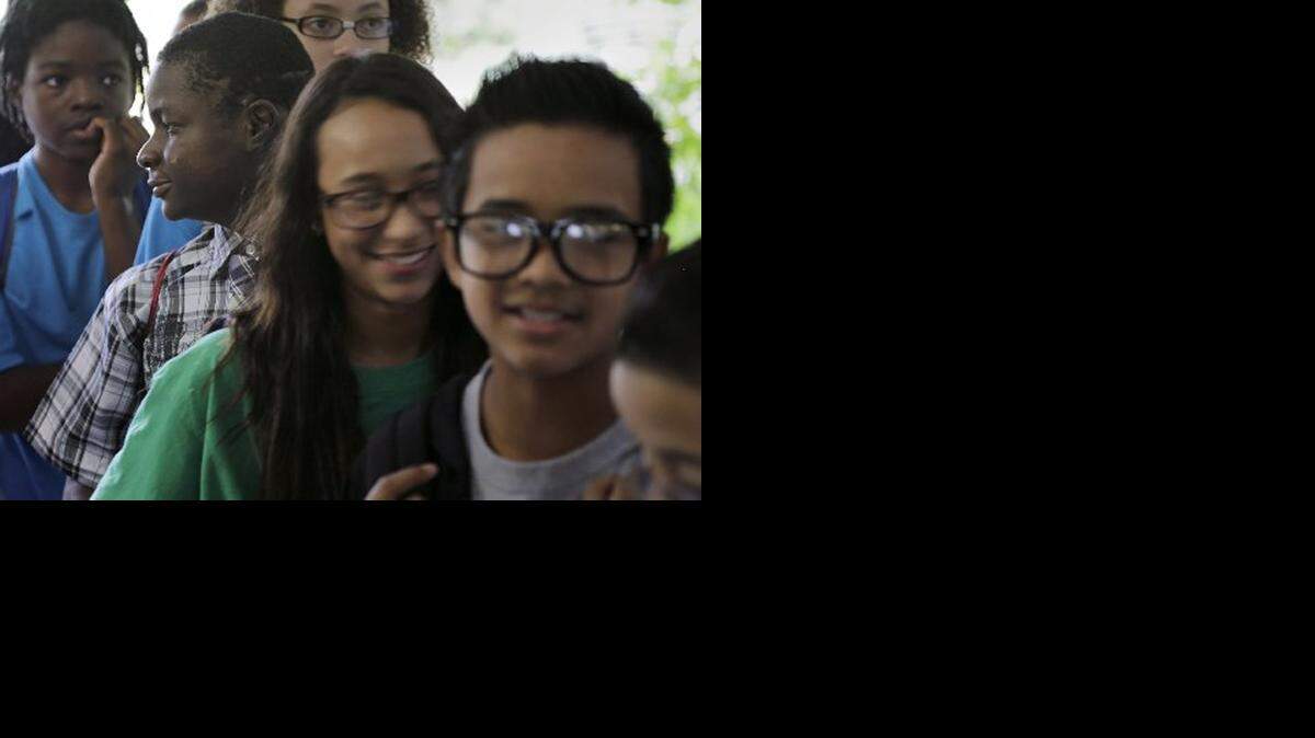 <cutline_leadin>THRIVING:</cutline_leadin> Peterson Exias looks off while waiting with students for a snack. Peterson survived 2010 Haiti quake and attended Breakthrough in 2013.