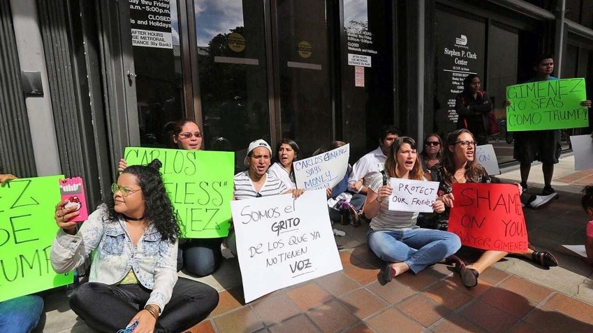 Protesters gather at the Miami-Dade Government Center to protest Mayor Carlos Gimenez’s decision to comply with Donald Trump’s executive order.