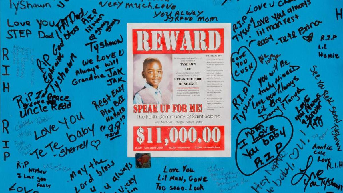 A reward sign and messages placed where Tyshawn Lee, age 9, was fatally shot in Chicago.