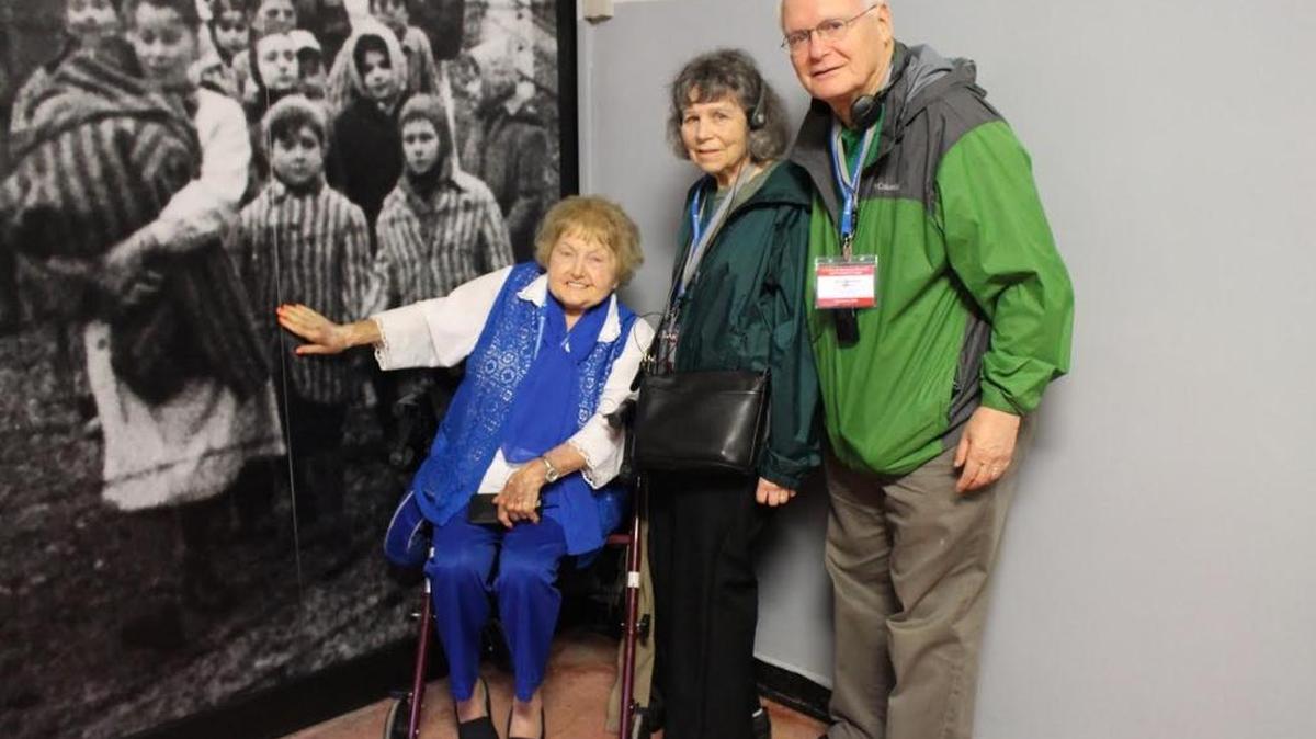 Roberta and Dave Lawrence, standing, at Auschwitz with Holocaust survivor Eva Mozes Kor, pointing to herself upon liberation in 1945.
