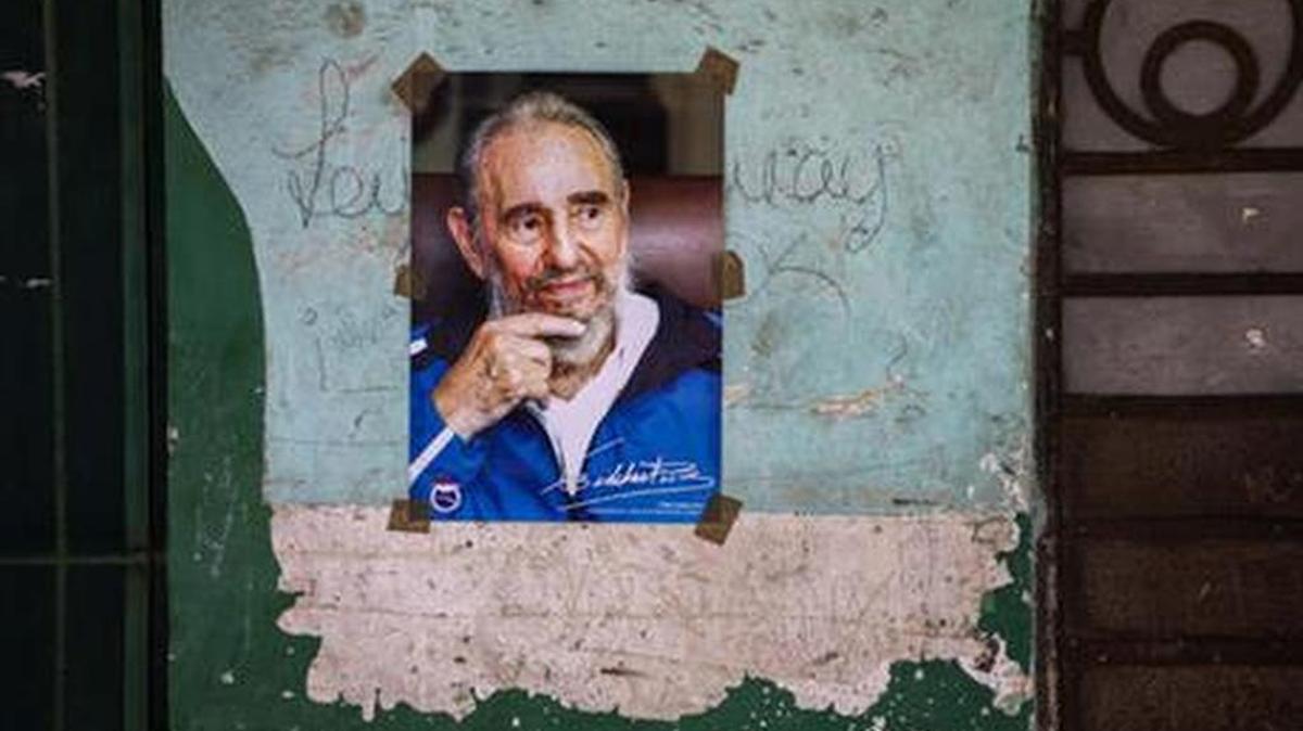 A peeling wall in Havana bears poster of Fidel Castro, who turned 90 this month.