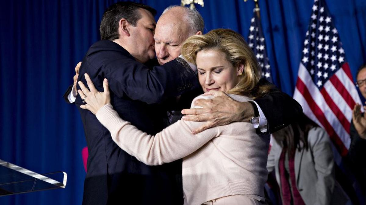 Sen. Ted Cruz embraces his father, Rafael Cruz, and wife Heidi after suspending his presidential campaign on Tuesday.