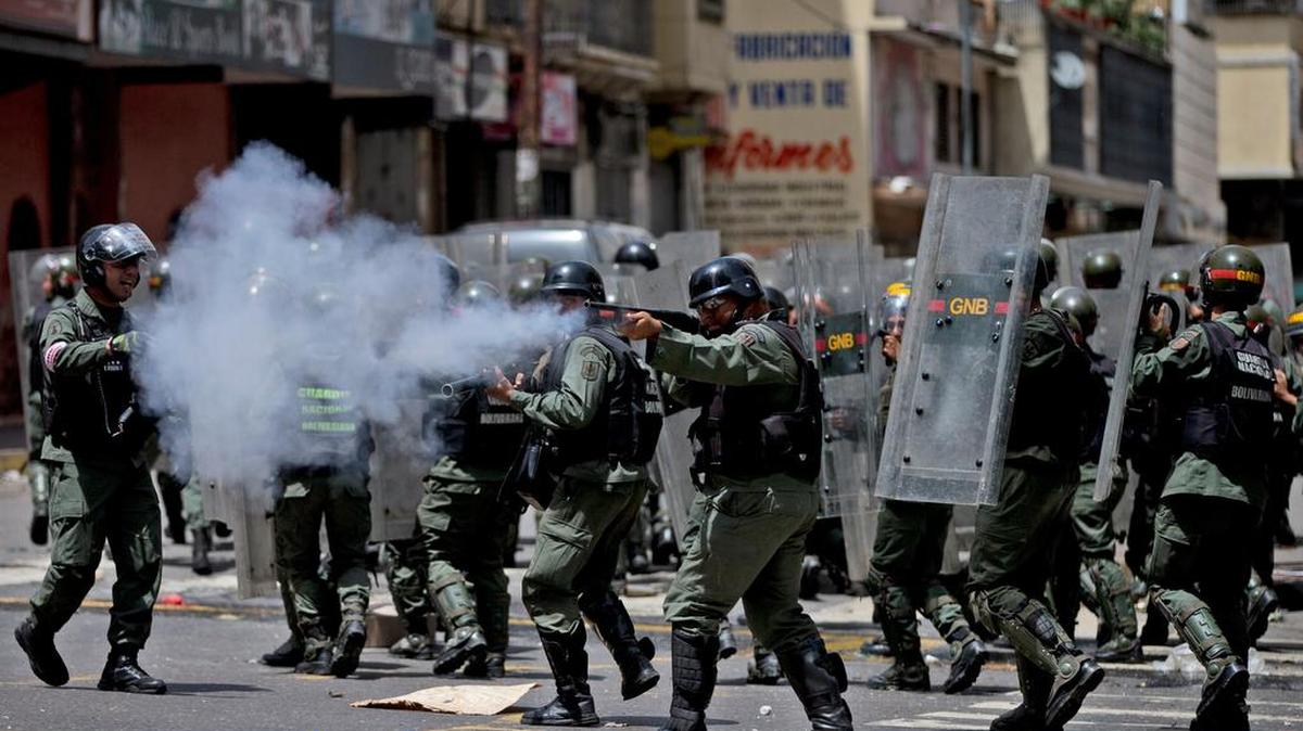 Venezuelan soldiers fire rubber bullets at people protesting for food last week in Caracas.