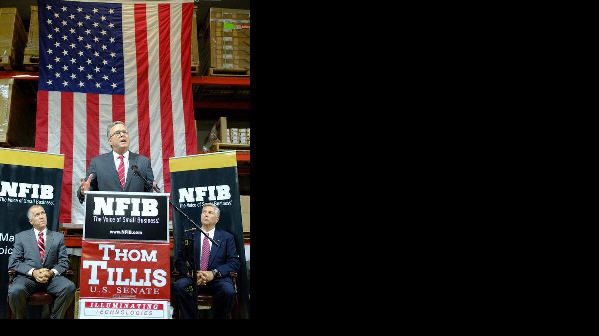 
STUMPING: Former Florida Gov. Jeb Bush speaks on behalf of North Carolina Republican Senate candidate Thom Tillis, left, at an event in Greensboro, N.C., last week.
