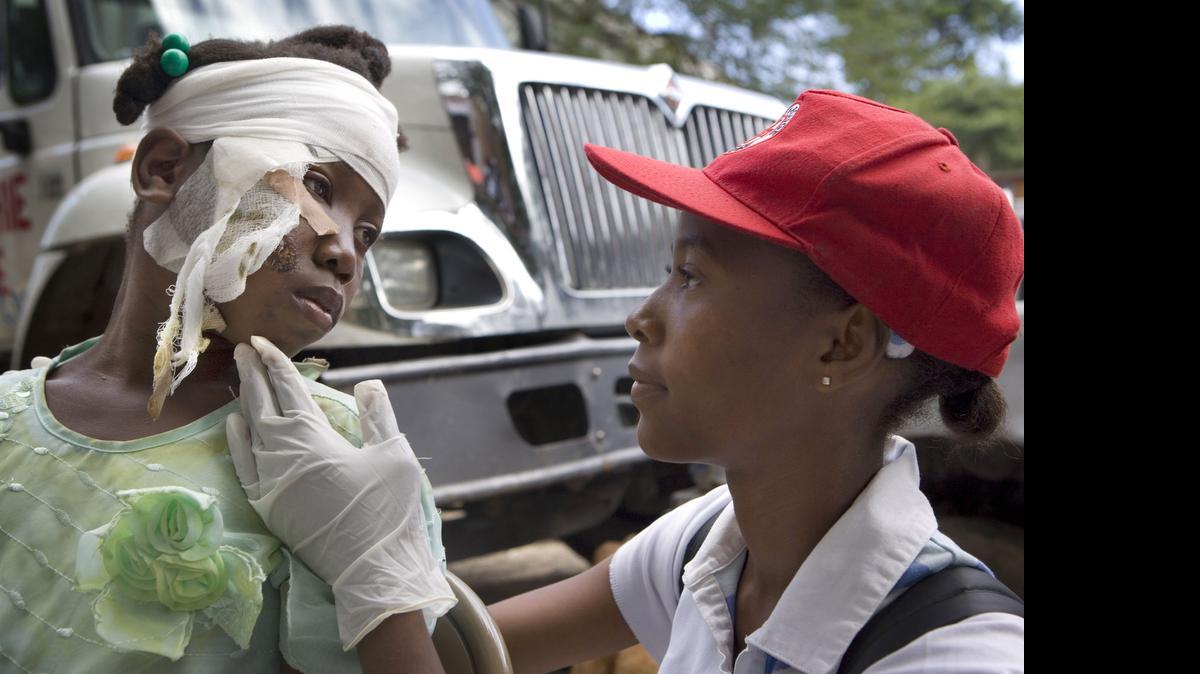
EARLY DAYS: An American Red Cross volunteer examines a victim of Haiti’s earthquake in the days immediately after the tragedy.
