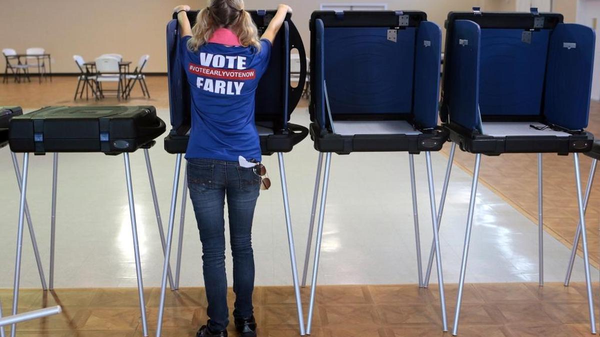 Erika Davidson sets up voting booths at the Panama City Beach Senior Center on Friday, Aug. 19, 2016, in Panama City Beach.