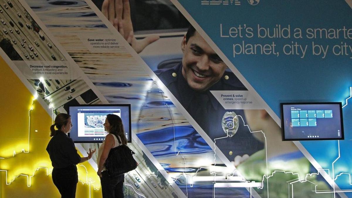 IBM marketing communications associate Marty Peterson, left, explains the Smarter Cities Initiative to Alejandra Slatapolsky at the 2014 eMerge Americas in Miami Beach. The annual event has pushed Miami into the technology spotlight.