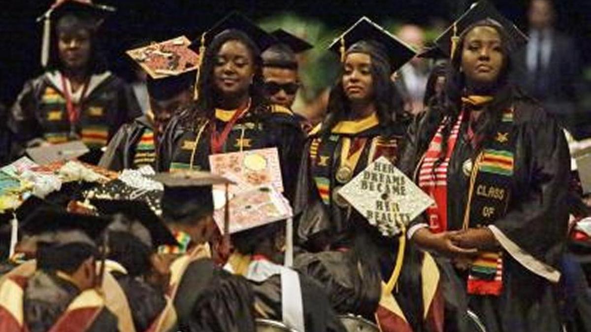 A group of students stand and turn their backs during a commencement speech by Education Secretary Betsy DeVos at Bethune-Cookman University on May 10, 2017.