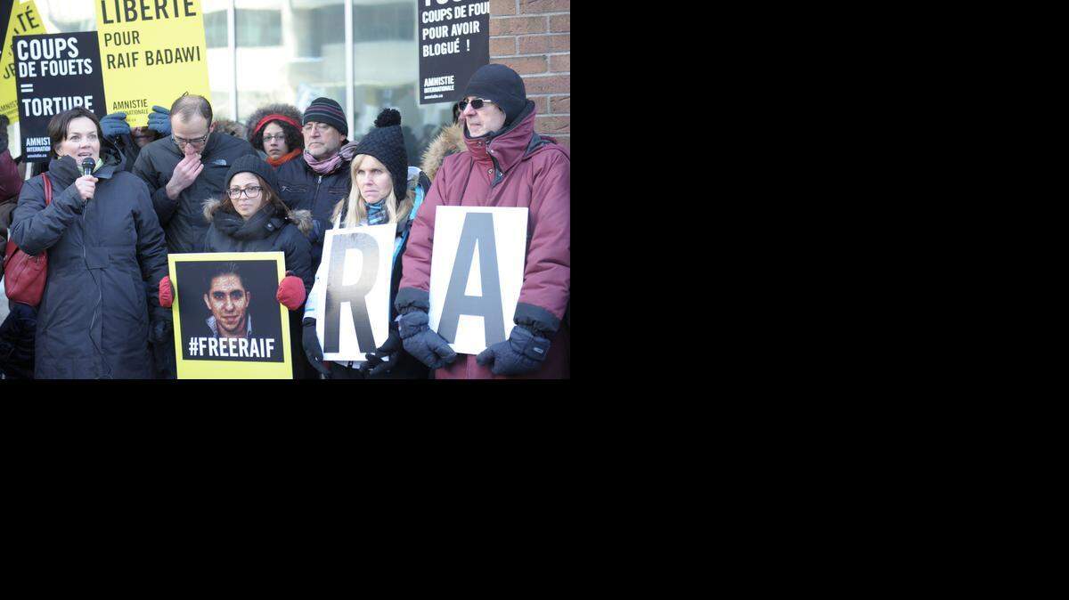 
SAUDI BLOGGER: Ensaf Haidar (center, holding his photo), the wife of the Saudi Blogger Raif Badawi, holds a vigil in Montreal on Tuesday urging Saudi Arabia’s government to free her husband, who was flogged in public in Jeddah, Saudi Arabia, for “insulting Islam.”
