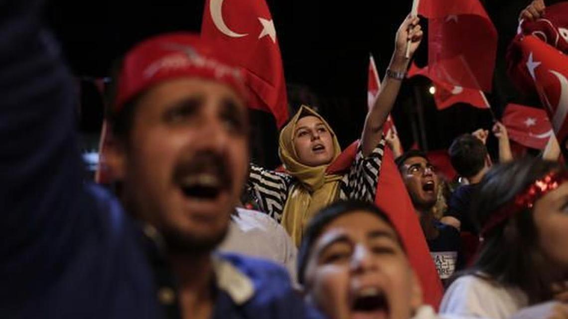Government supporters wave Turkish flags during a rally in Istanbul after attempted coup.