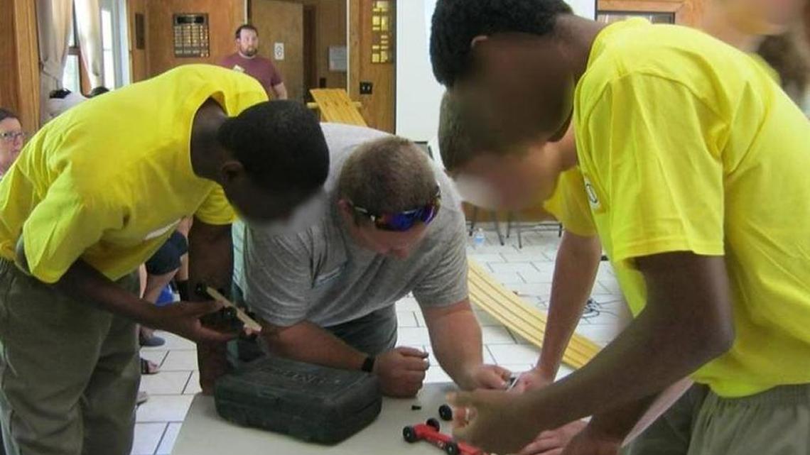 DJJ education staff work with youths at the inaugural Pinewood Derby Challenge between students at two DJJ residential facilities to design and build cars.