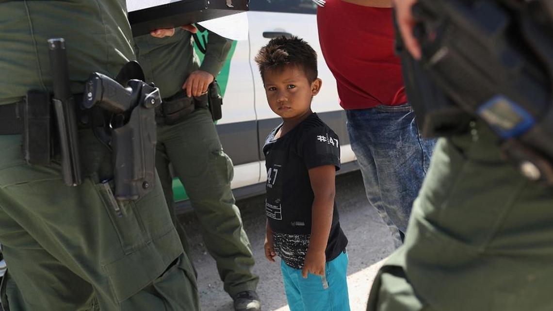 U.S. Border Patrol agents take a father and son from Honduras into custody near Mission, Texas, in June.