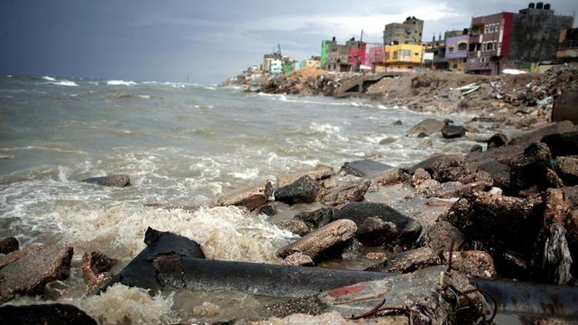 Sewage flows from an outlet into the sea in front of Shati refugee camp in Gaza City. Each day, millions of gallons of raw sewage pour into the Gaza Strip's Mediterranean beachfront, spewing out of a metal pipe and turning miles of once-scenic coastline into a stagnant dead zone. But Israel and Palestinians have recently negotiated a deal to address the problem.