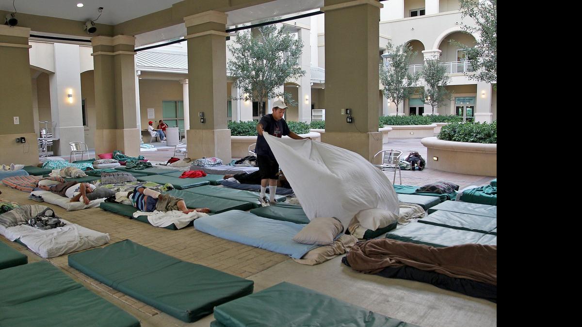 
HOMELESS: Some 1,000 homeless people, like these in an Overtown shelter, are estimated to remain on Miami streets.
