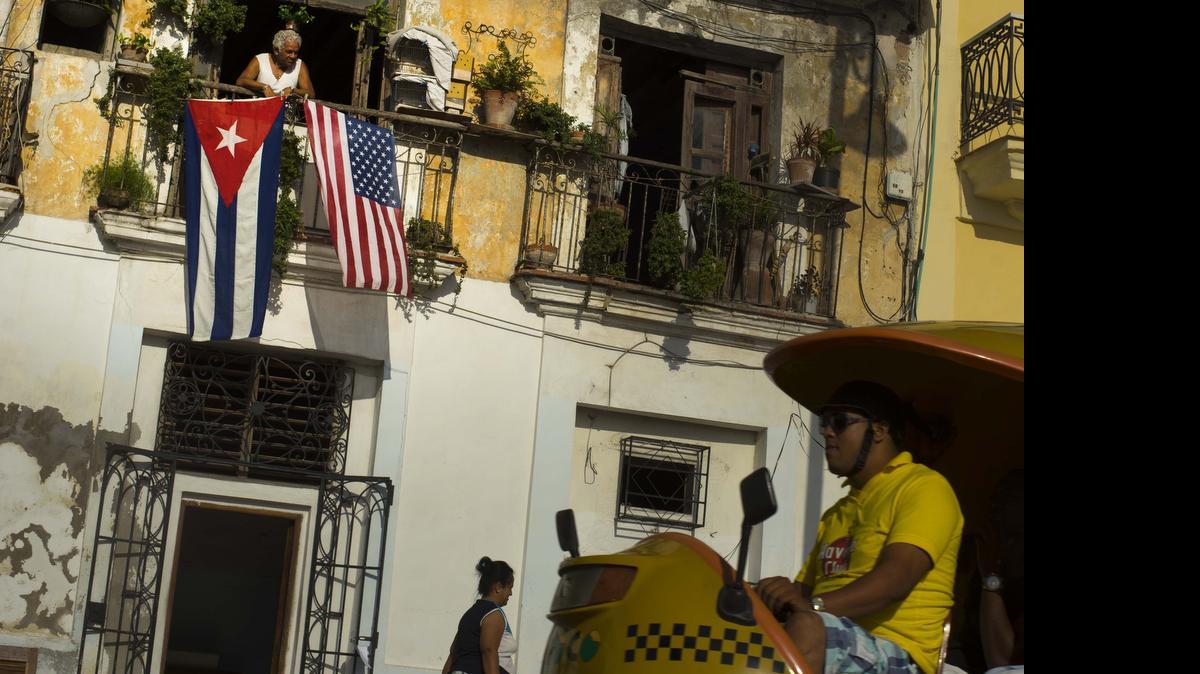 
RARE SIGHT: American and Cuban flags drape a balcony in Old Havana on Monday to celebrate the restoration of full diplomatic relations. 
