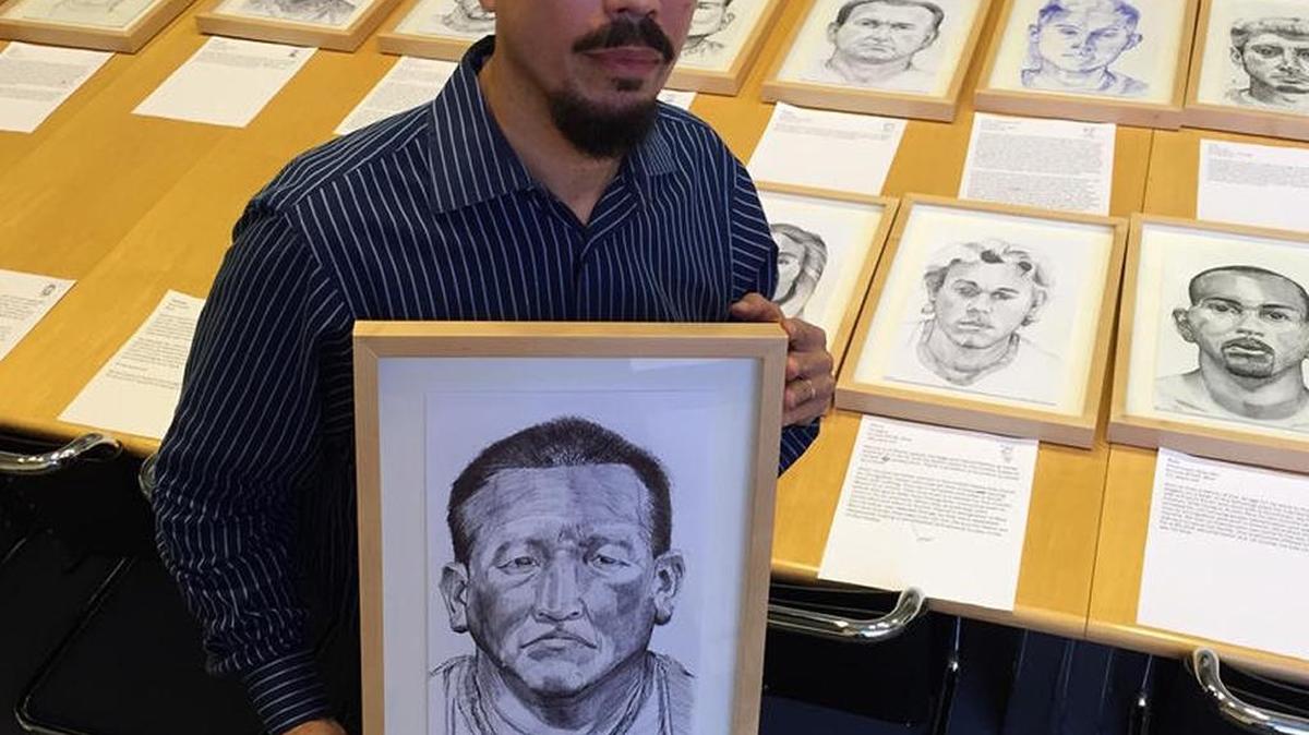 Jose Alvarez, holding his portrait of Roberto, from Guatemala, has an exhibit of his work at the Boca Raton Museum of Art.