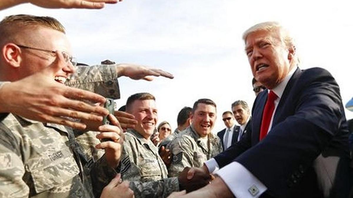 President Donald Trump greets members of the military after he arrives on Air Force One at Harrisburg International Airport in Middletown, Pennsylvania, on Saturday.
