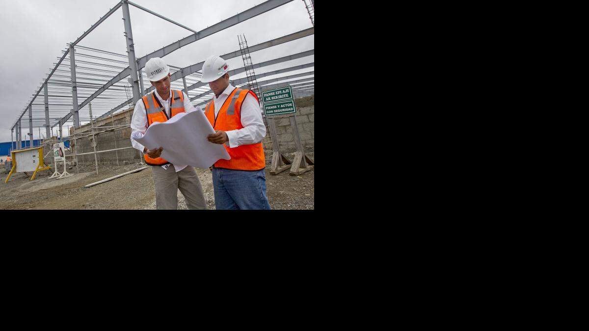 
HAITI RECOVERY: Construction workers look over plans as they work on a project in the new Caracol Industrial Park.
