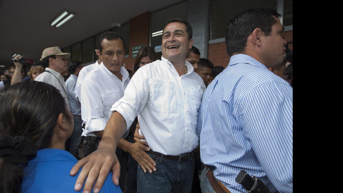 
CENTRAL AMERICA: Honduran President Juan Orlando Hernandez, second from right, campaigning for office in 2013, has admitted that he received financing from businesspeople linked to a huge graft and embezzlement scandal.
