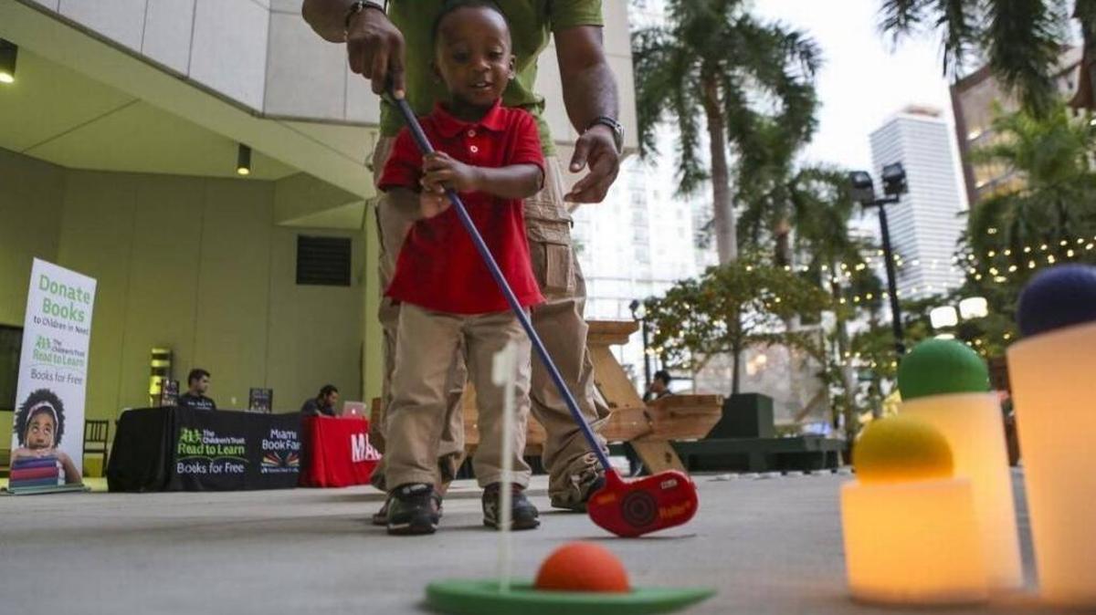 On the Miami Foundation’s Give Miami Day in 2016, Iaan Barnett Jr., 2, plays with his dad, Iaan Barnette Sr., during a block party at Miami Dade College.