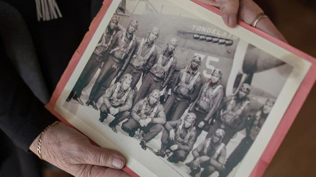 Marla Andrews holds a photograph of Tuskegee Airman, including her father, Capt. Lawrence E. Dickson.