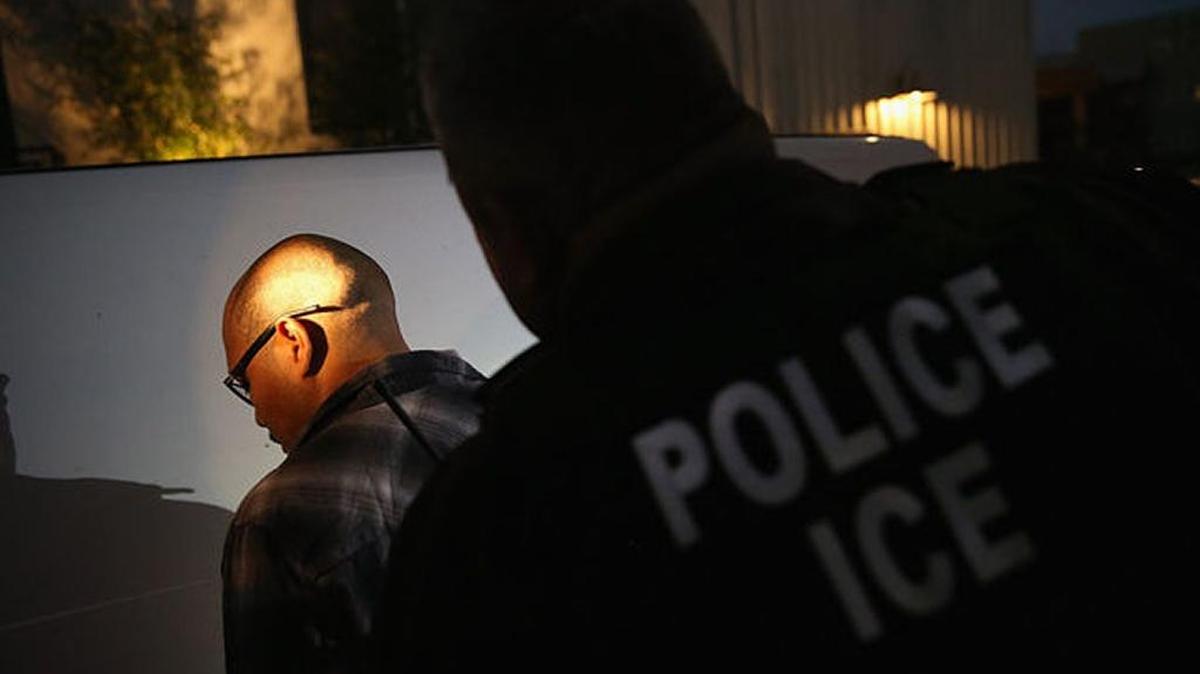 An undocumented immigrant is detained by Immigration and Customs Enforcement agents in Los Angeles. Agents said he was a convicted criminal and gang member.