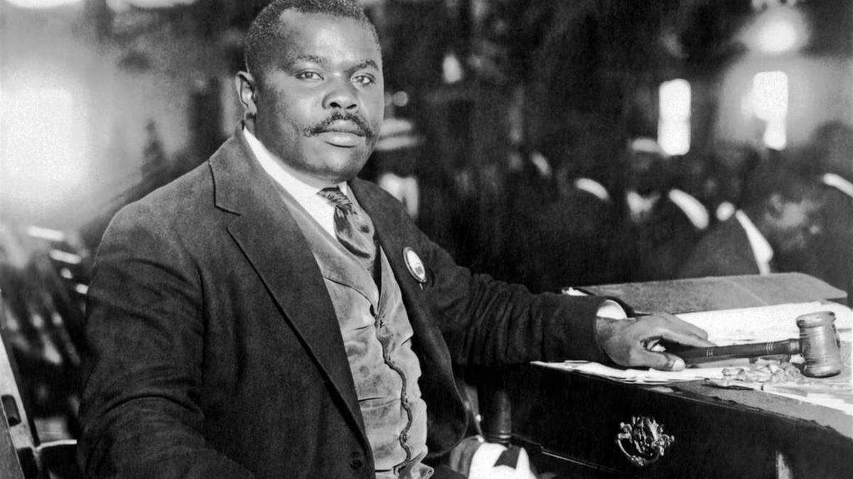 Civil-rights advocate Marcus Garvey seated at his desk in 1924.