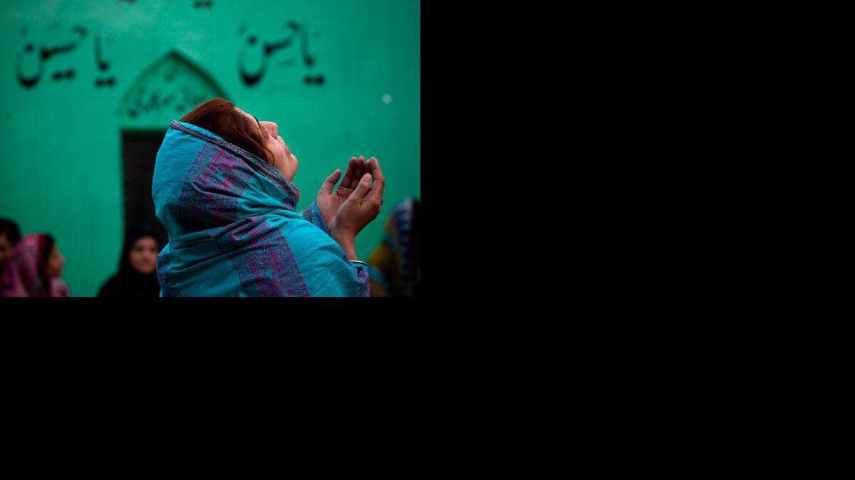 
A woman prays at a shrine in Pawalpindi, Pakistan.
