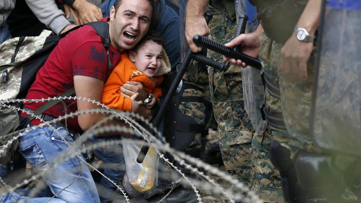 Refugees from Syria try to cross into Macedonia from Greece. More than a million people like them have arrived in Europe, the U.N. said last month.