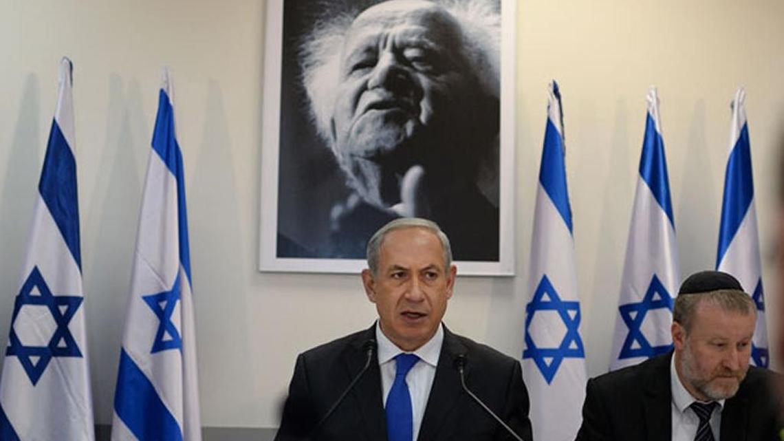 Prime Minister Benjamin Netanyahu delivers a speech under a portrait of David Ben Gurion, founder of the state of Israel.
